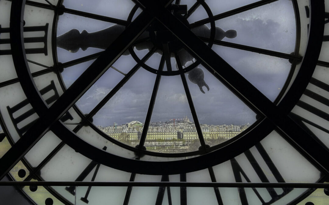 "Louvre Museum" seen through the clock at Musée d'Orsay